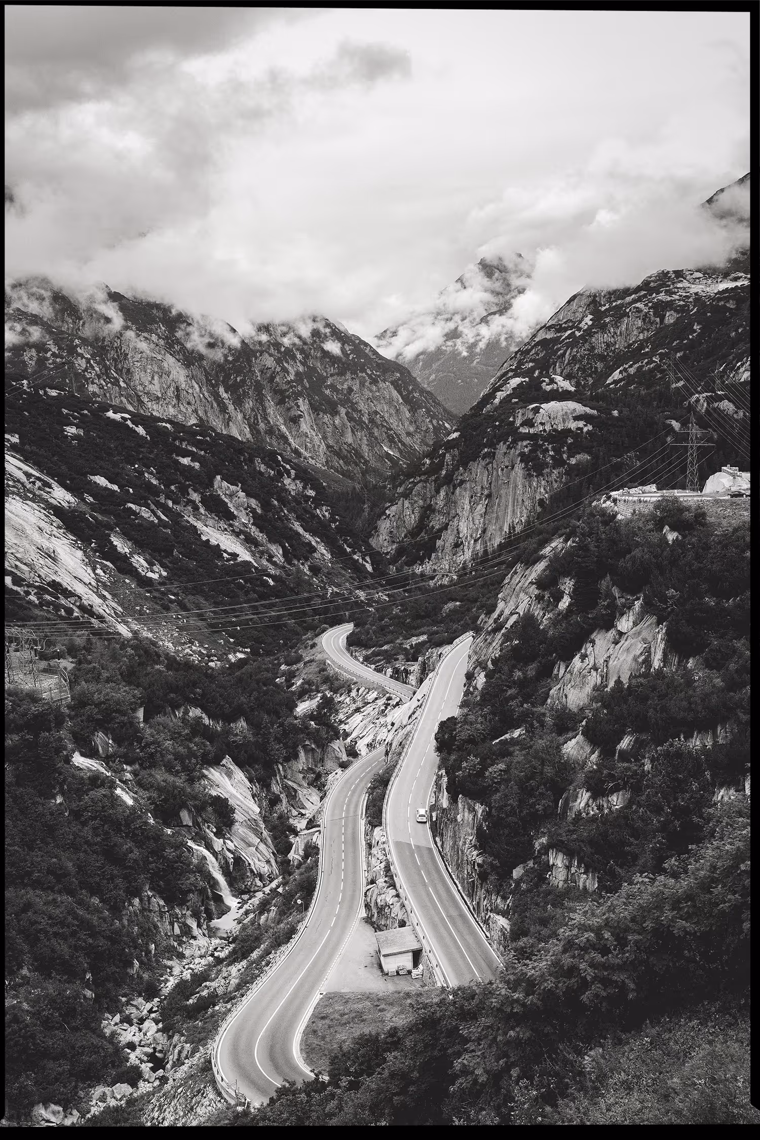 An alpine road winding at the base of the Oberhasli power plant