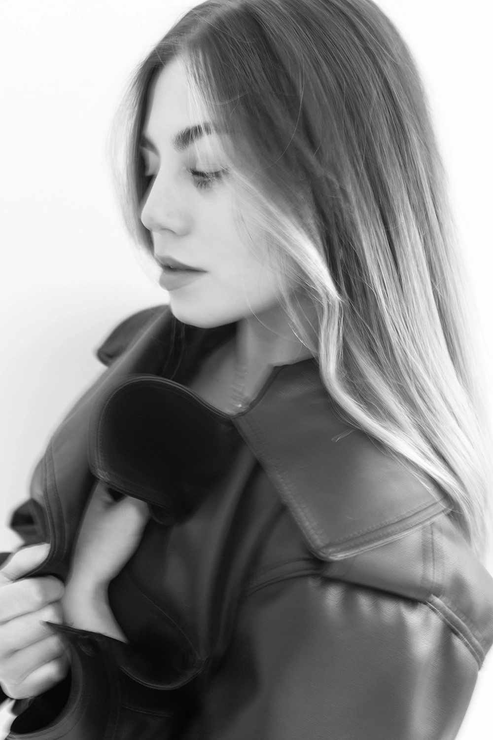 The girl in a leather jacket against a white  background