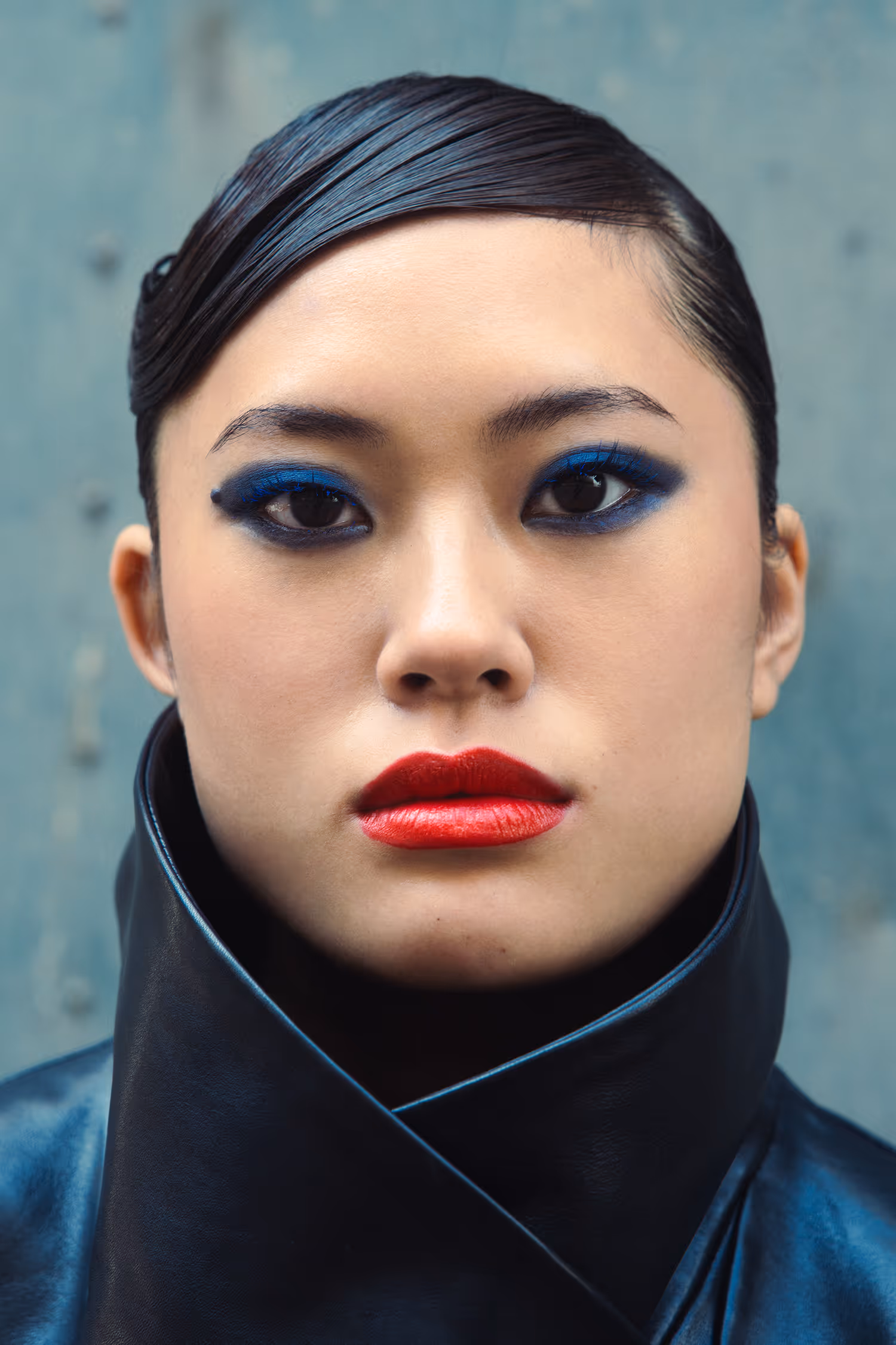 Woman in a black leather coat looking straight ahead